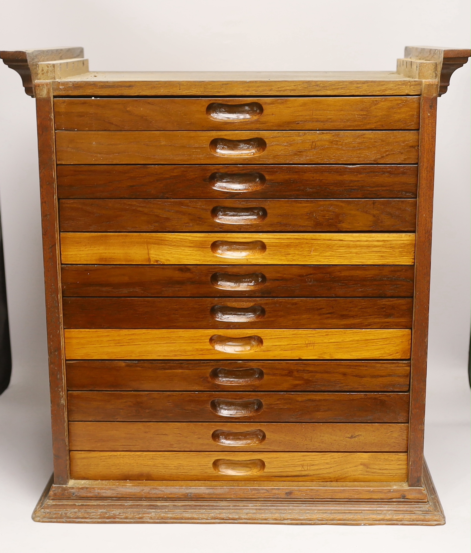 A twelve drawer mahogany collector’s cabinet with unusual sliding front cover, each shallow drawer containing two additional felt lined removable trays, possibly suitable for a coin collection, watch parts, etc. 55cm hig